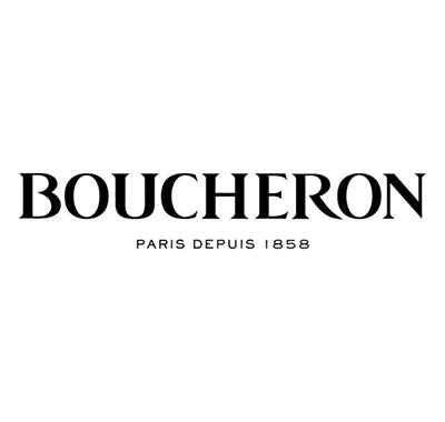 Boucheron Pour Femme perfume bottle with gold detailing and classic round shape, Jaïpur Homme cologne bottle with ornate design and rich amber liquid, Woman holding Boucheron perfume with elegant Parisian backdrop
