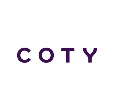Coty branded fragrance bottles displayed on a white surface, Collection of Coty perfumes with colorful packaging, Close-up of Coty perfume bottle with elegant design, Woman applying Coty fragrance in bright, natural light,