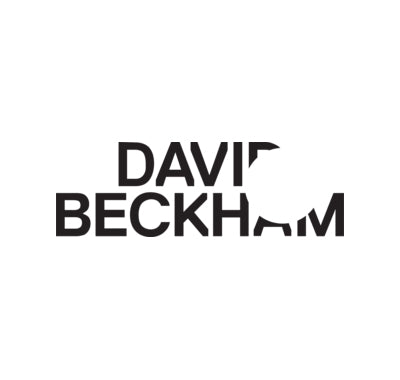 David Beckham Instinct men's fragrance bottle with sleek design,David Beckham fragrance set with branded packaging and accessories, Close-up of David Beckham Homme perfume with masculine styling, Man applying David Beckham cologne in stylish dressing room