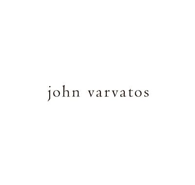 John Varvatos Classic Eau de Toilette bottle with leather-wrapped design, John Varvatos Vintage fragrance with dark amber bottle and textured label, Flat lay of John Varvatos fragrance trio on wooden surface