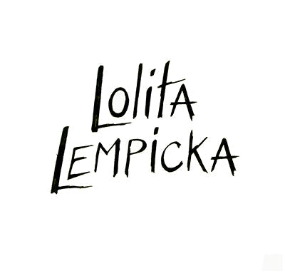 Lolita Lempicka Le Premier Parfum bottle in apple-shaped design – front view, Lolita Lempicka fragrance gift set with elegant packaging – flat lay shot, Close-up of Lolita Lempicka perfume bottle with gold accents and violet hues